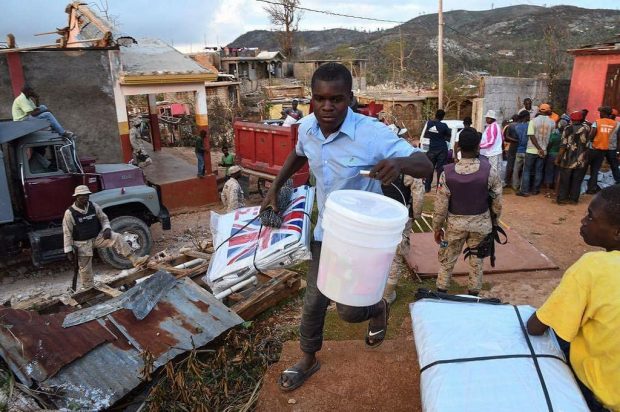 Hygiene kits and tarpaulins for temporary shelter supplied by UK aid being distributed in Haiti in 2016. Picture: Carey Wagner/CARE