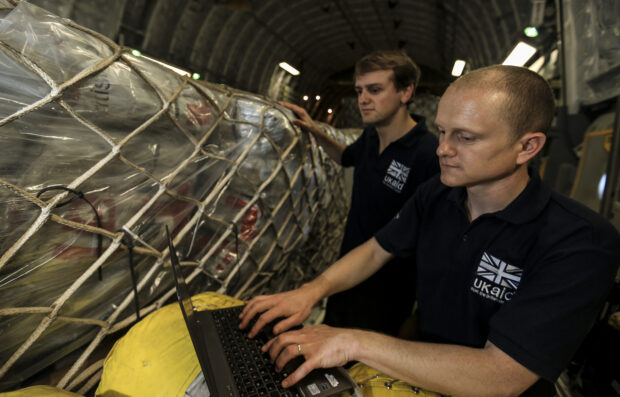 DFID Humanitarian Advisors check humanitarian aid supplies on board an RAF C-17 aircraft. Picture: Sgt Neil Bryden RAF